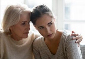Close up of loving empathetic elderly mother or grandmother calming show sympathy to grown up daughter or granddaughter in difficult life situations break up heart break personal life problems concept